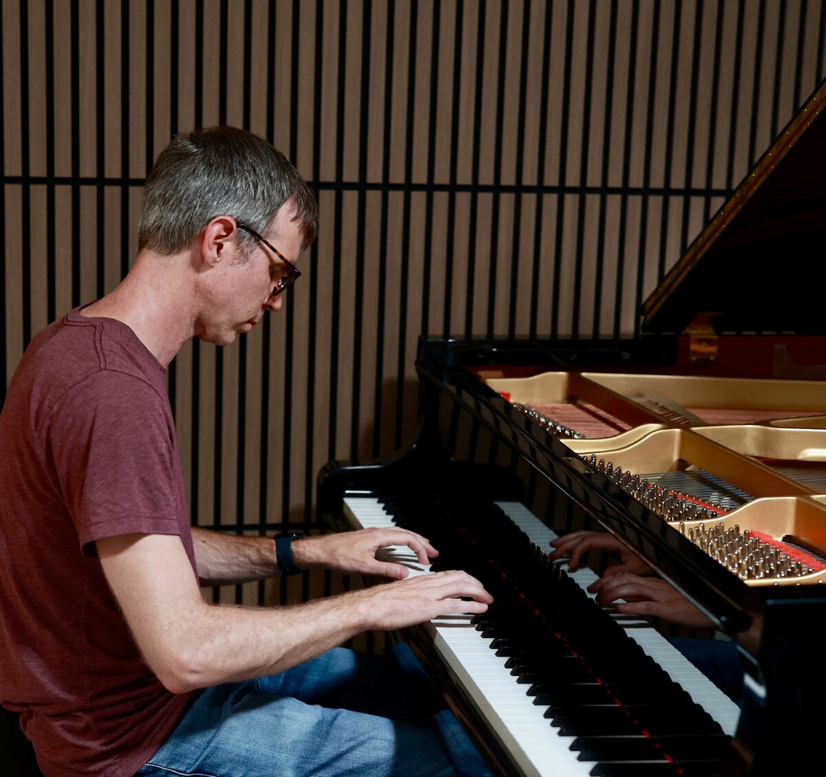 Ben Hughes playing a grand piano